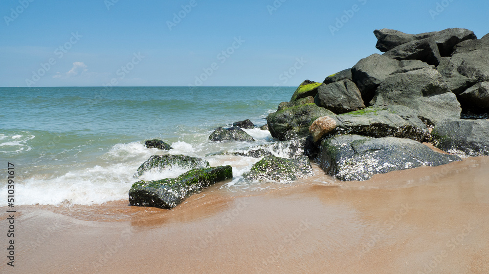 Ocean waves splashing on rocks at the the seashore