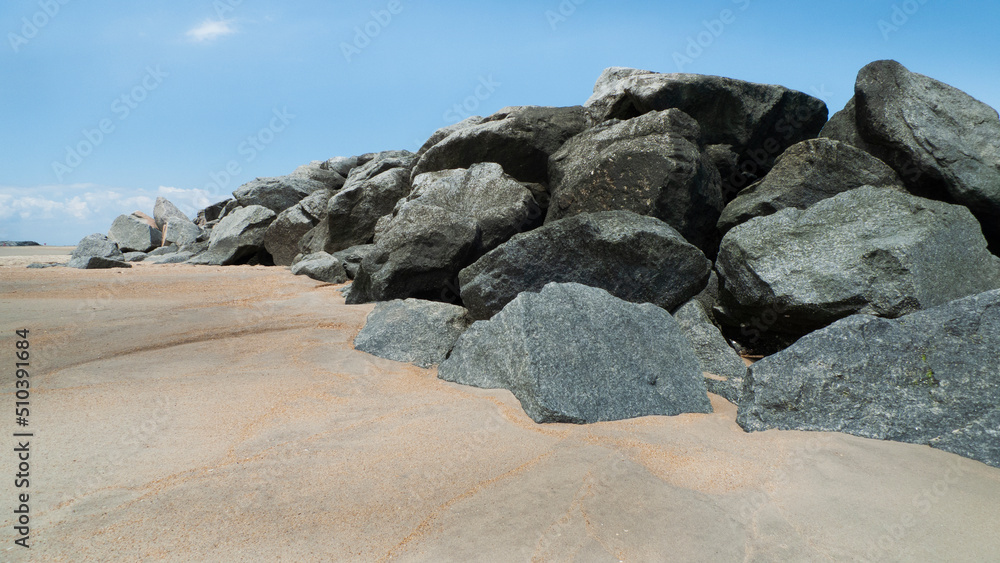 Boulders and sand with blue skies