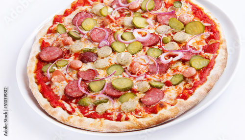 pizza with salami red onion and cornichons on white plate