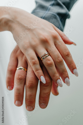 male and female hand with wedding rings