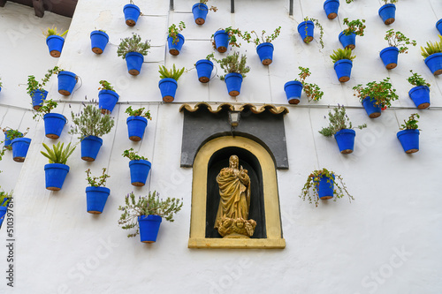 White wall decorated with blue flower pots at traditional Spanish Village Poble Espanyol in Barcelona, Spain