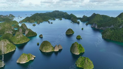 Aerial view of scattered islands with blue ocean water at Wajag Island, Raja Ampat, West Papua, Indonesia. photo
