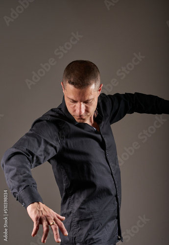 A man posing in a photographic studio