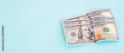 Stack of dollar banknotes on blue background. American national currency