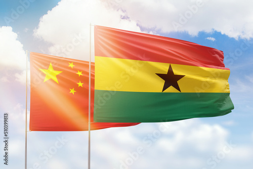 Canvas Print Sunny blue sky and flags of ghana and china