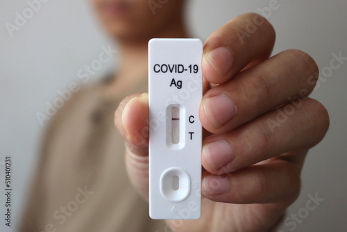 Close up Antigen Test kit : Man holding Rapid Antigen Test kit with show negative result during swab COVID-19 testing