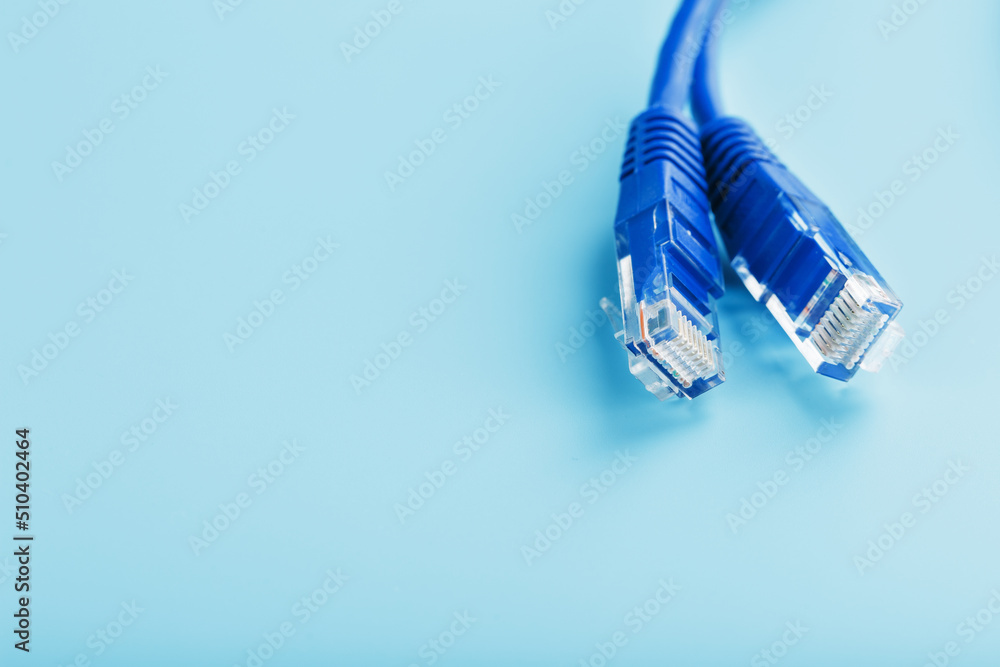 Blue Ethernet Cable Cord Patch cord on a blue background with free space Blue Ethernet Cable Cord Patch cord on a blue background with free space