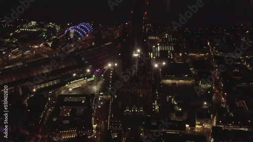 Wallpaper Mural High angle view of tall religious landmark. Cathedral Church of Saint Peter with tall towers and illuminated square in front of train station at night. Cologne, Germany Torontodigital.ca