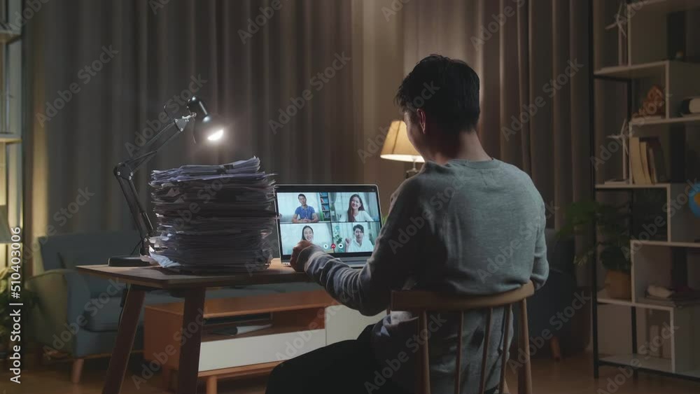 Back View Of Asian Man Having Video Call On Laptop While Working With Documents At Home
Back View Of Asian Man Having Video Call On Laptop While Working With Documents At Home