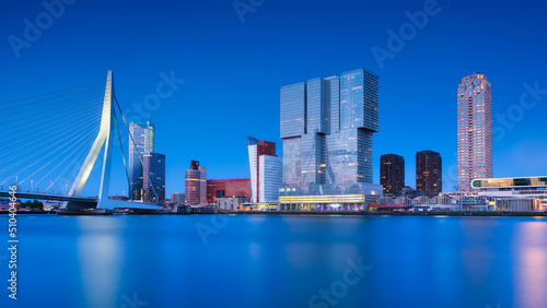 Rotterdam, Holland. View of the Erasmus Bridge and the city center. Panoramic view. Cityscape in the evening. Skyscrapers and buildings.
