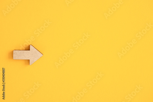 Business investment growth concept , Wooden arrows on yellow background. Space for your text photo