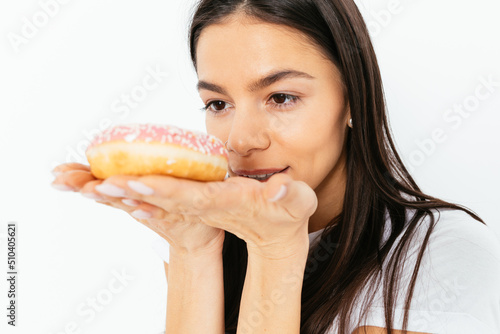 Portrait of young woman desiring to eat donut
