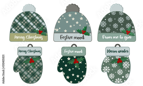 A set of Christmas decorations for congratulations in the form of a winter hat and mittens with patterns in a cage and snowflakes