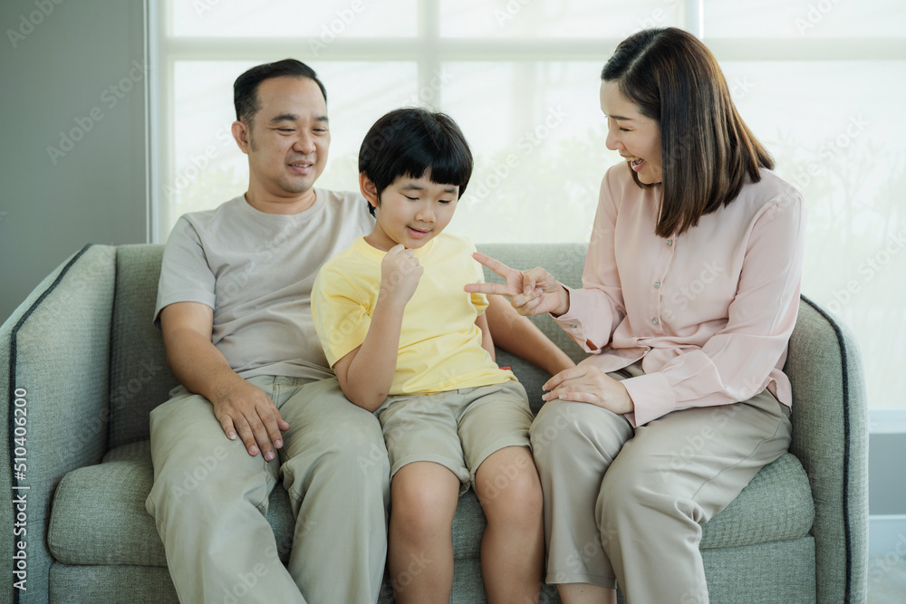 Smiling young parents and their child are very happy, Mum and dad and boys laughing and hugging. Happy family Smiling young parents and their child are very happy, Mum and dad and boys laughing and hugging. Happy family
