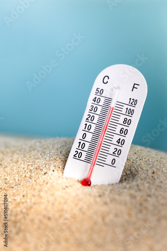 Weather thermometer with high temperature outdoors in the sand