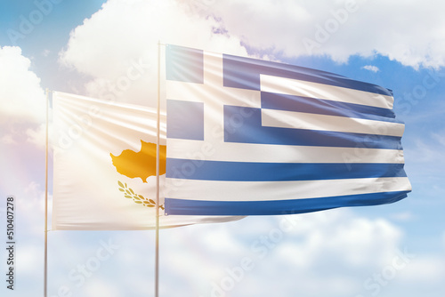 Sunny blue sky and flags of greece and cyprus photo