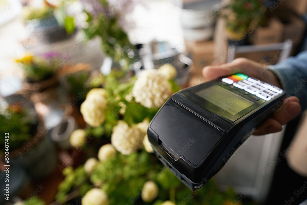 Man working with cashless payments in flower shop Man working with cashless payments in flower shop