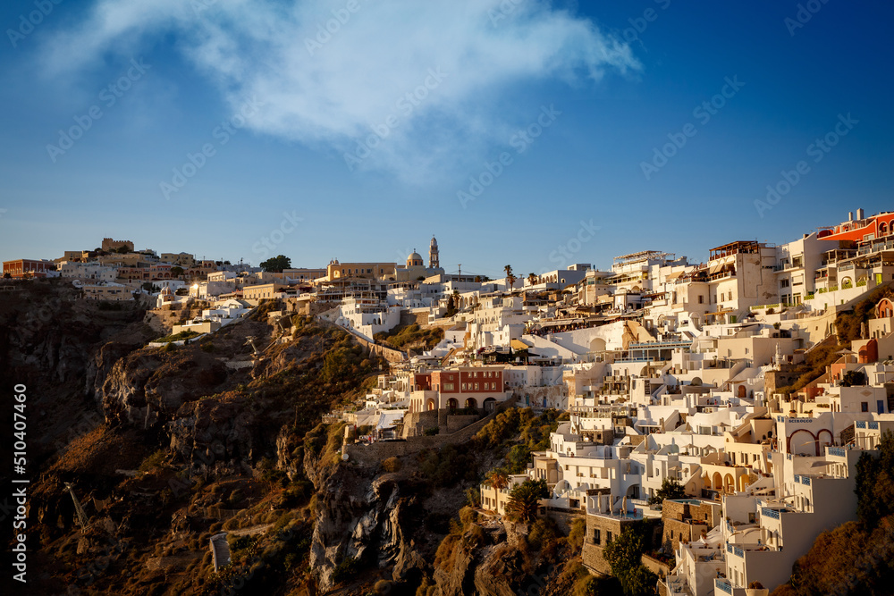 Greek white architecture village on a hillside near the sea.