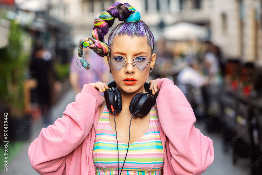 Cool funky young woman with trendy eyeglasses listening music on headphones outdoor - obrazy, fototapety, plakaty 