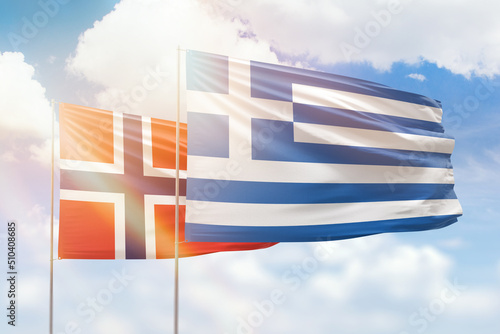 Sunny blue sky and flags of greece and norway