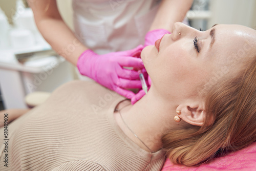 Beautiful pretty lady enjoying during the beauty procedure in cosmetology center