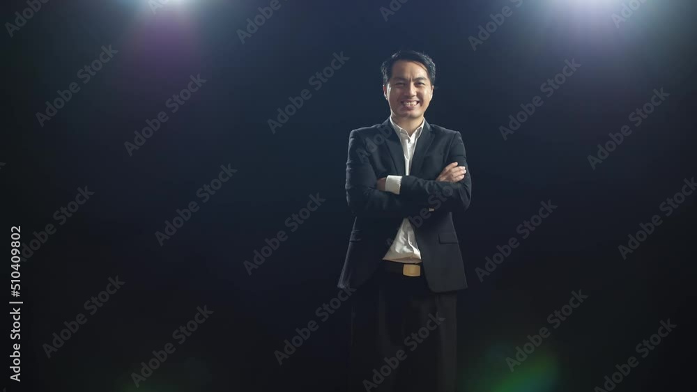 Smiling Asian Speaker Man In Business Suit Crossing His Arms While Standing In The Black Screen Studio
Smiling Asian Speaker Man In Business Suit Crossing His Arms While Standing In The Black Screen Studio