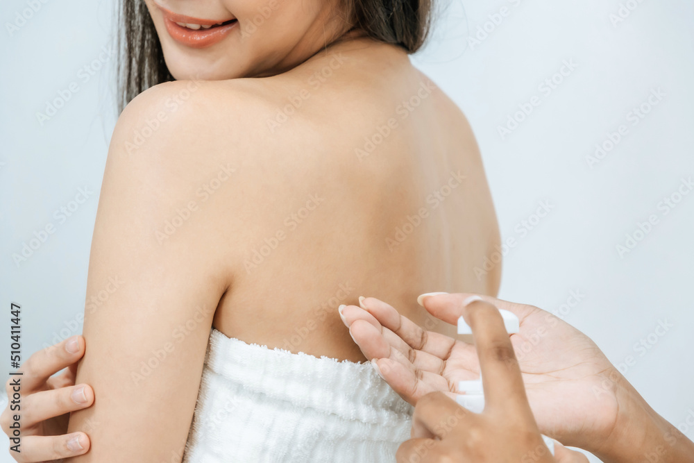 two beautiful young girl friend in towel applying white body cream on back in bed room at home, body treatment, skin care, cosmetic, beauty treatment spa, healthy body, sun protection concept two beautiful young girl friend in towel applying white body cream on back in bed room at home, body treatment, skin care, cosmetic, beauty treatment spa, healthy body, sun protection concept