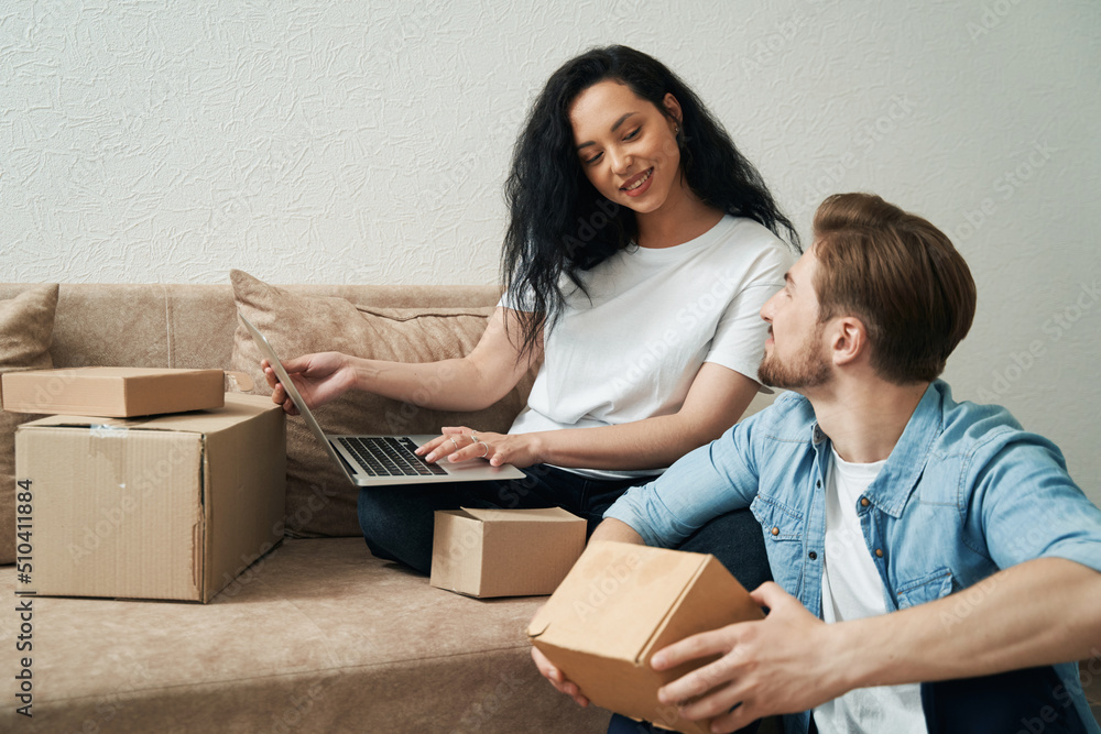 Joyous woman and man buying items over Internet Joyous woman and man buying items over Internet