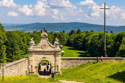 Fototapeta Naklejka Na Ścianę i Meble -  Swiety Krzyz, Poland - June 5, 2022: Lysa Gora, Swiety Krzyz mount hilltop with gate to medieval Benedictive Abbey and sanctuary in Swietokrzyskie Mountains near Nowa Slupia village in Poland