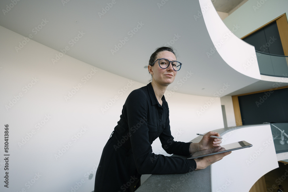 Business woman using tablet pc in minimalist office interior Business woman using tablet pc in minimalist office interior