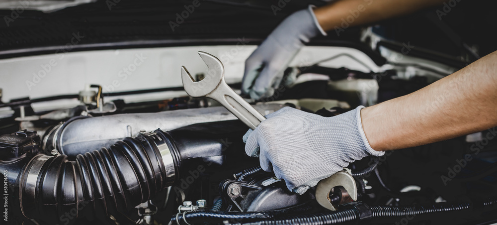 Mechanic works on the engine of the car e in the garage,car repair ...