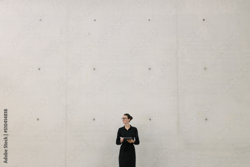 Business woman using tablet pc in minimalist office interior Business woman using tablet pc in minimalist office interior