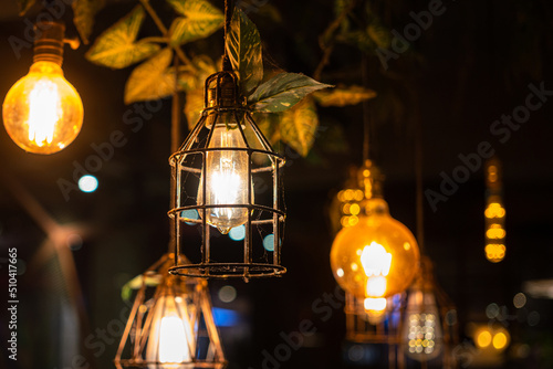 Group of retro style ceiling lighting lamp with warming light glowing bulb. Interior decor, selective focus object. Photo contained some noise and high constrast ratio due to low light condition. photo