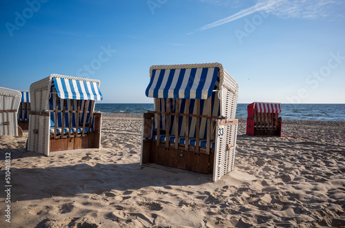 Strandkorb providing shelter from sun and wind. Hooded Wicker beach chairs on a beach at the baltic sea in Bansin  Usedom  Germany