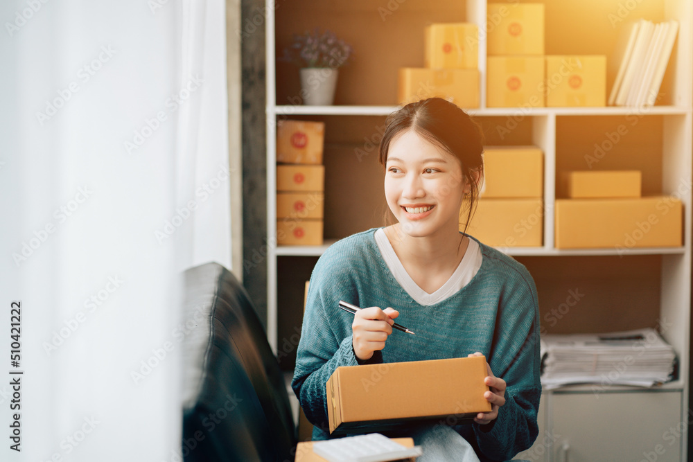 Asian teenager owner business woman work at home for online shopping and sale. Asian teenager owner business woman work at home for online shopping and sale.