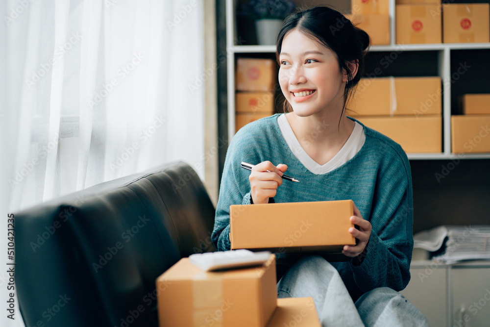 Asian teenager owner business woman work at home for online shopping and sale.