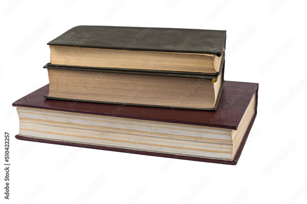 A stack of books isolated against a white background. Large red book and two green ones. Closed books with yellowed pages. Hardcover. Literature, reading, knowledge. Close-up. Selective Focus. A stack of books isolated against a white background. Large red book and two green ones. Closed books with yellowed pages. Hardcover. Literature, reading, knowledge. Close-up. Selective Focus.