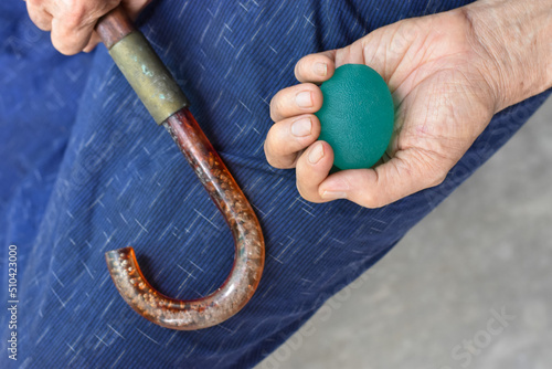  Asian elder man gripping hand exercise elastic ball. photo