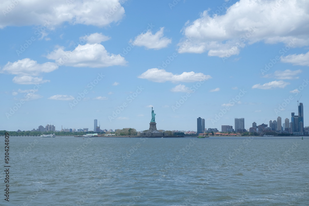 New York city cityscape over Hudson river. Statue of Liberty.