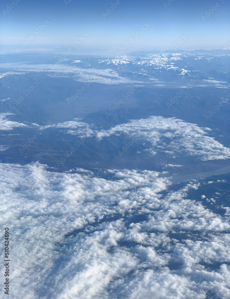 Aerial view of mountains and sky from plane, selective focus. Aerial view of mountains and sky from plane, selective focus.