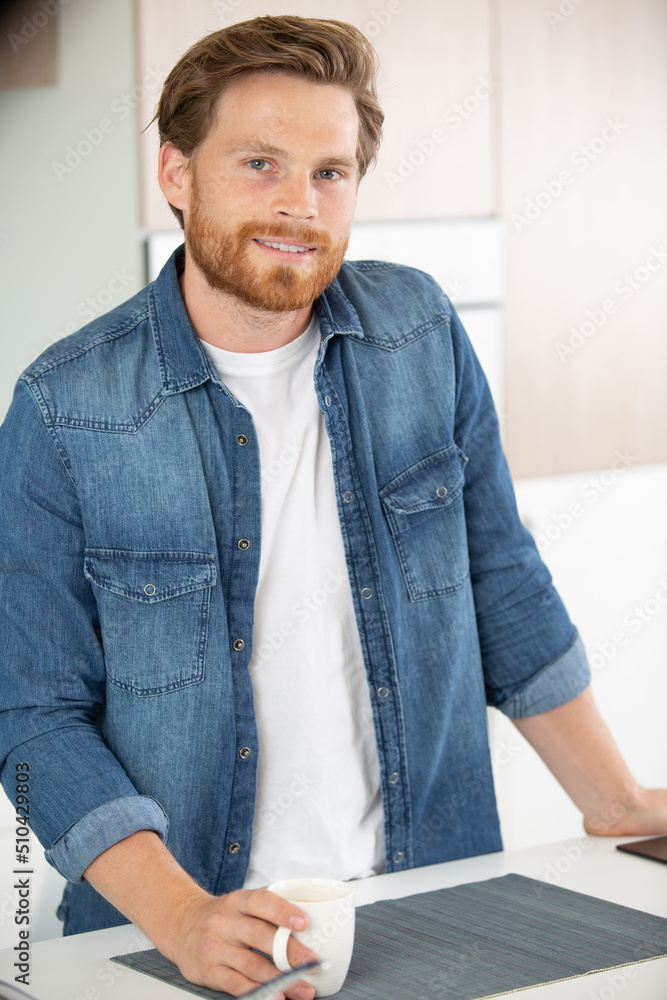 Fototapeta premium handsome man drinks coffee at home