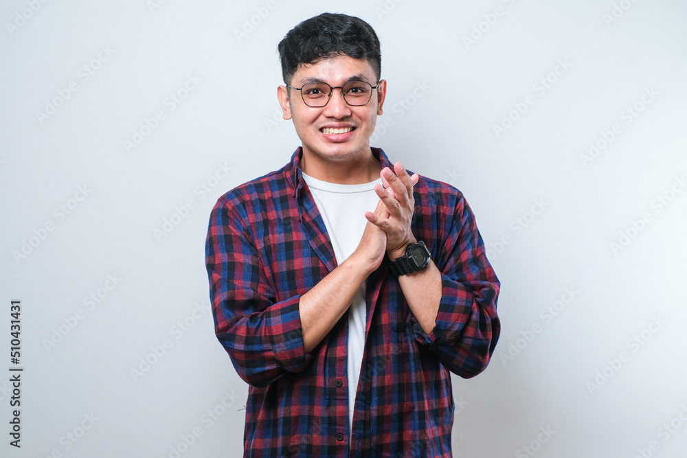 Young handsome asian man clapping and applauding happy and joyful, smiling proud hands together Young handsome asian man clapping and applauding happy and joyful, smiling proud hands together