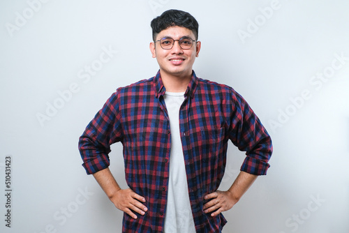 Young asian traveler man confident keeping hands on hips