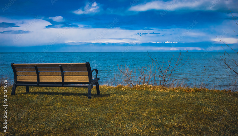An empty bench overlooking Lake Erie in Geneva-On-The-Lake, Ohio