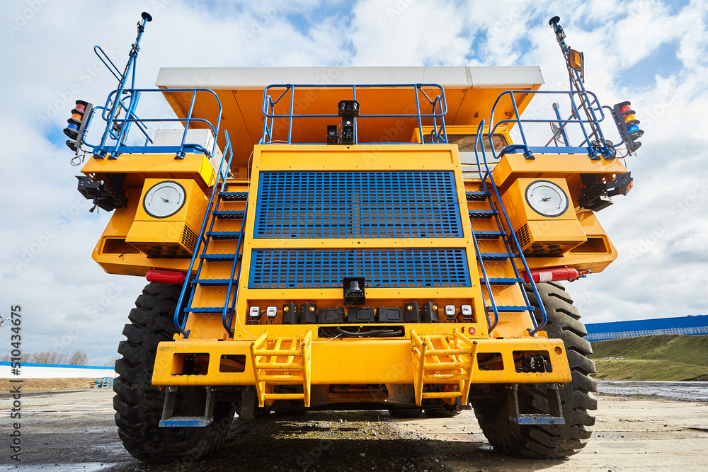 A large dump truck. Yellow dump truck controlled by a robot on the work site. Mining equipment for transporting coal with open-pit mining A large dump truck. Yellow dump truck controlled by a robot on the work site. Mining equipment for transporting coal with open-pit mining