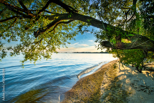 Scenery from the beautiful sandy setting of the Big Sandy Bay beach on Wolfe Island in Frontenac County near Kingston Ontario Canada. Windmills and beautiful water landscapes.