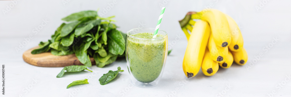 Vegetarian green smoothie with avocado, spinach leaves, banana in glass on gray concrete background. Raw, vegan, vegetarian, alkaline food, Healthy Lifestyle detox concept. Selective focus. Vegetarian green smoothie with avocado, spinach leaves, banana in glass on gray concrete background. Raw, vegan, vegetarian, alkaline food, Healthy Lifestyle detox concept. Selective focus.