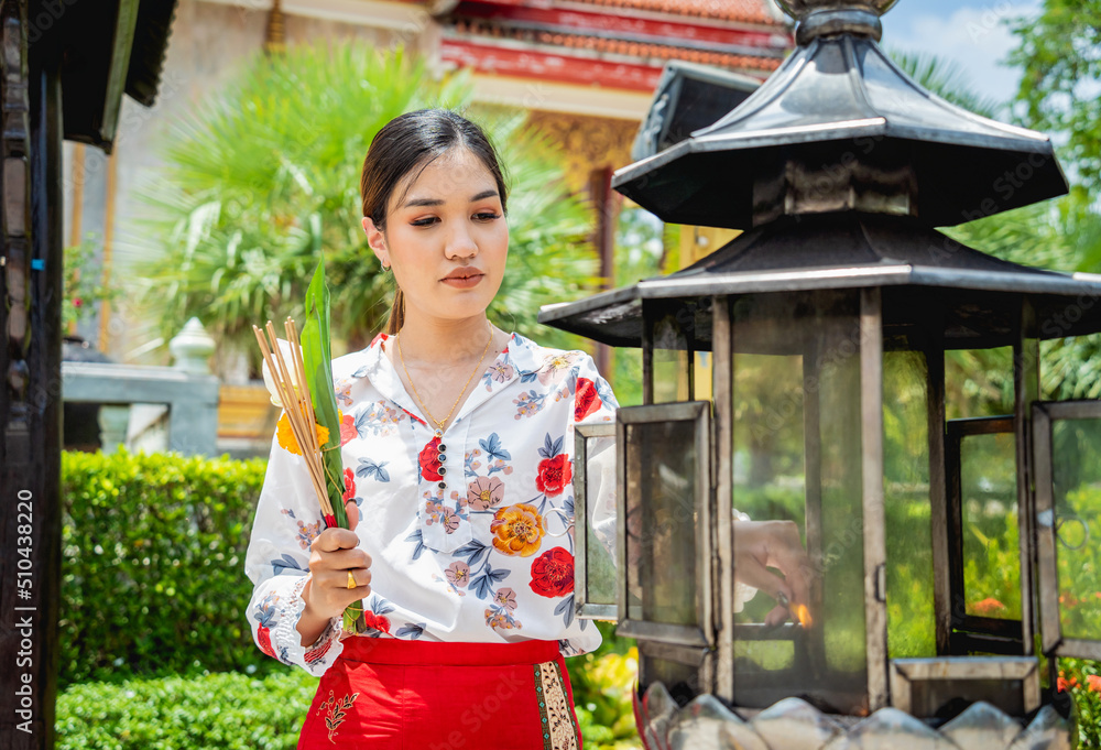 Fototapeta premium Beautiful Asian girl at big Buddhist temple dressed in traditional costume