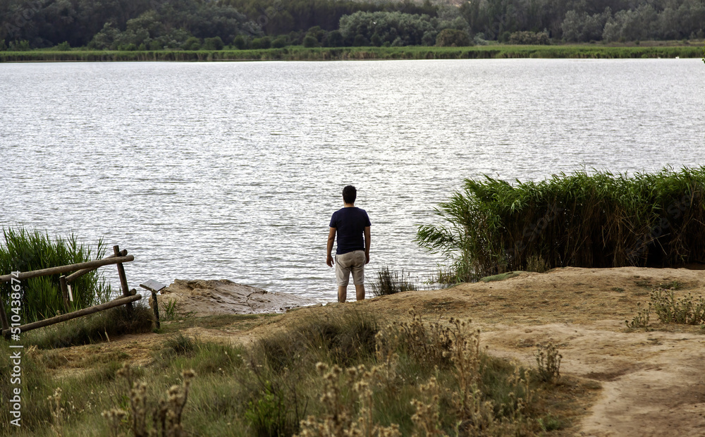 Man looking at the lake