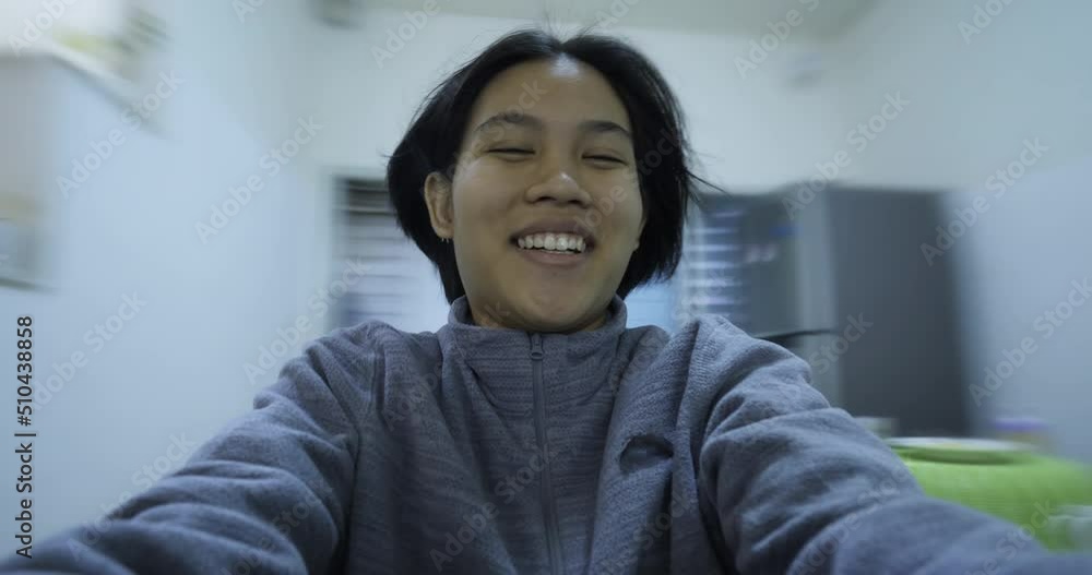 Cute asian woman spins around in a white room Cute asian woman spins around in a white room